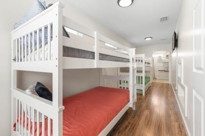 After sun-soaked beach days, this bunk room becomes the kids’ own little world—late-night whispers, movie wind-downs, and sleepy smiles tucked into beds…