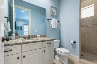Cool coastal tones and a spacious walk-in shower make this bright bath a refreshing place to begin and end the day.