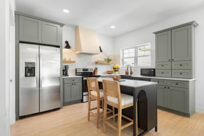 Everything a real cooking week needs: full-size fridge, electric range, a tall pantry and an island with room to spread out on.