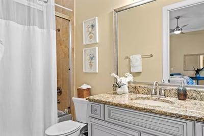 Fresh, bright, and beach-ready This clean, well-appointed bathroom features granite counters and a walk-in shower—perfect for rinsing off after a day at the…