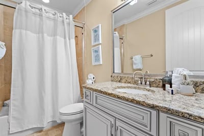 Bright, clean, and beach-ready This well-appointed bathroom features granite counters, a full tub and shower, and fresh towels—everything you need for easy…